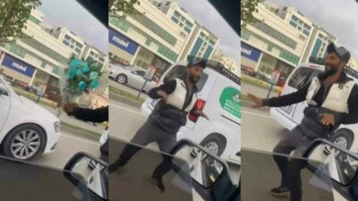 Bursa’da lambalarda araçların arasında seyyar çiçekçilik yapan vatandaş, araç içinden